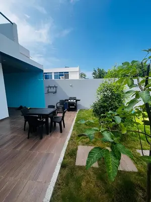 a patio with tables and chairs on a roof at AzulRest Casa de Verano in Santa Veronica