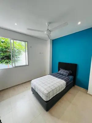 a bedroom with a bed and a blue wall at AzulRest Casa de Verano in Santa Veronica