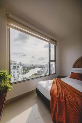 a bedroom with a bed and a large window at SkyMar Luxury 27 in Cartagena de Indias