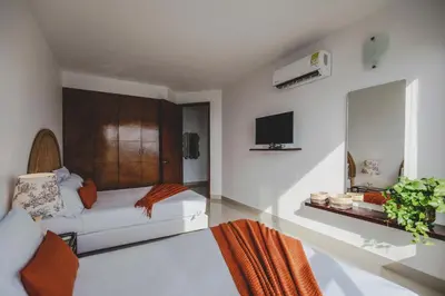 a living room with a couch and a tv at SkyMar Luxury 27 in Cartagena de Indias