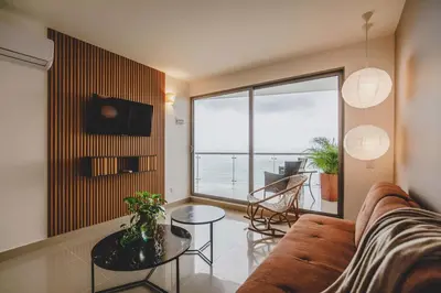 a living room with a couch and a view of the ocean at Frente Al Mar Ciudad Antigua Home Office 14B in Cartagena de Indias