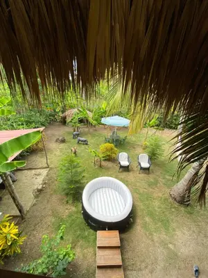 a backyard with a table and chairs and a picnic table at Cabañas roble verde in Rincón