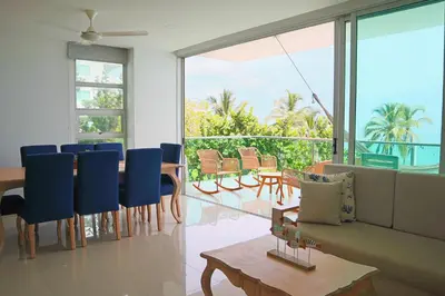a living room with a table and blue chairs at Magico Apartamento Frente al Mar 3 Habitaciones TR21 in Coveñas