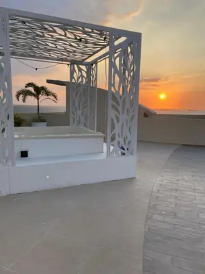 a view of a balcony with a sunset in the background at Infinity Blue - Playa Dormida in Santa Marta