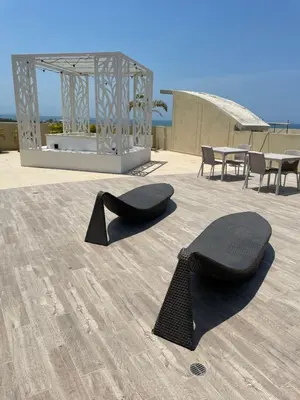 a pair of black chairs sitting on top of a patio at Infinity Blue - Playa Dormida in Santa Marta