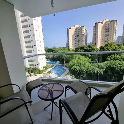 a balcony with chairs and a table and a view at Torres del Mar Santa Marta in Santa Marta