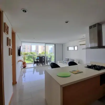 a kitchen and living room with a couch and a table at Torres del Mar Santa Marta in Santa Marta