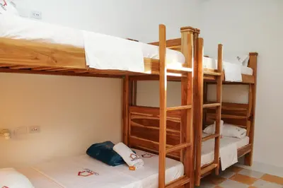a bunk bed room with three bunk beds in it at Hostal Casa Torres Centro Historico - Adults Only in Cartagena de Indias
