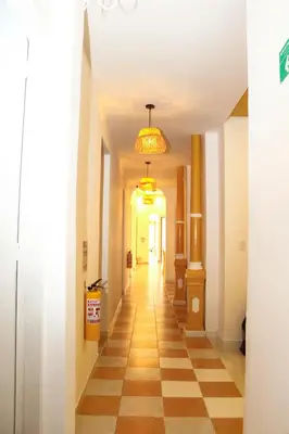 a hallway with a checkered floor and a chandelier at Hostal Casa Torres Centro Historico - Adults Only in Cartagena de Indias