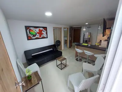 a living room with a couch and a table and chairs at Apartamento en cartagena in Cartagena de Indias