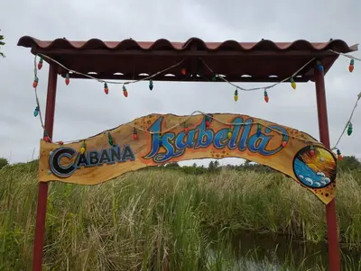 a sign that says calama jestoria in front of a field at Cabaña Isabella in San Bernardo del Viento