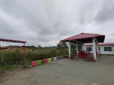 a group of people sitting in a pavilion at a playground at Cabaña Isabella in San Bernardo del Viento