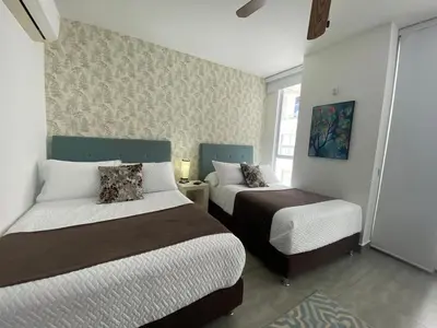 a bedroom with two beds in a room at Ctgna 10 personas 3 habitaciones Playa Américas Morros in Cartagena de Indias