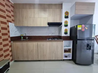 a kitchen with a refrigerator and a sink at Hermoso Apartamento Cerca a la Playa Puerto Colombia in Puerto Colombia