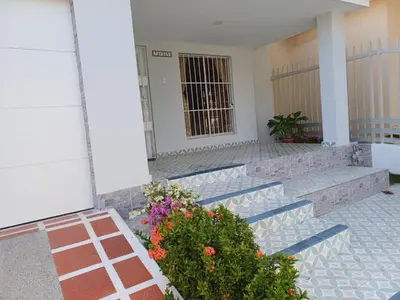 a building with stairs and flowers in front of it at Casa Bellavista Barranquilla in Barranquilla