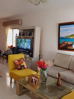 a living room with a couch and a tv at Casa Bellavista Barranquilla in Barranquilla