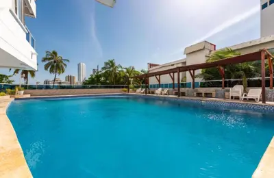 a swimming pool in the middle of a building at Cartagena apto estudio piso 12 frente a la playa in Cartagena de Indias