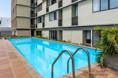 a swimming pool in front of a building at Coco Paraiso Baranquilla - Hermosos Apartamentos Cercanos Al Malecón Del Rio in Barranquilla