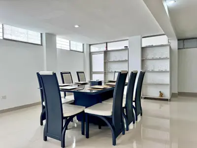 a dining room with a blue table and chairs at HELENE HOUSE in Sincelejo