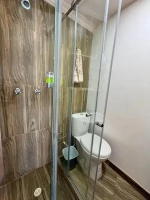a bathroom with a toilet and a glass shower at El Laguito, Edificio El Conquistador in Cartagena de Indias