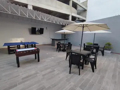a room with ping pong tables and umbrellas at Cozy room Bm-10 near the sea with air conditioning and WIFI in Cartagena de Indias