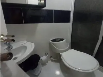 a bathroom with a white toilet and a sink at Bm-3 room near the sea with air conditioning and WIFI in Cartagena de Indias
