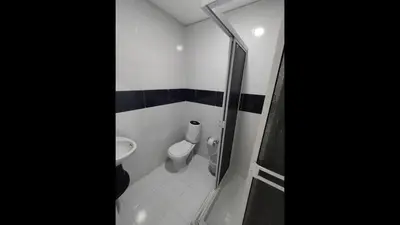 a small bathroom with a toilet and a shower at Bm-1 room near the sea with air conditioning and WIFI in Cartagena de Indias